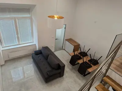 a living room with a couch and a table at Basilica in Maribor