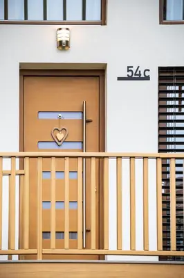 a door with a heart on it on a building at Cozy House Claudia in Žirovnica