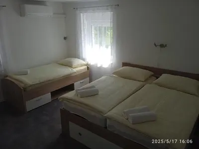two twin beds in a bedroom with a window at Apartment One2one in Bovec