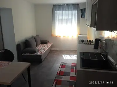 a small living room with a couch and a window at Apartment One2one in Bovec