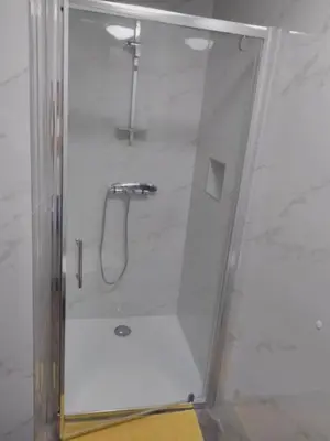 a shower with a glass door in a bathroom at Apartment One2one in Bovec
