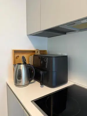 a microwave and a tea kettle on a kitchen counter at OTTA Apartments Golte C1 in Mozirje