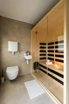 a bathroom with a toilet and a sink and a shower at Wellba Holiday Home Otlica in Ajdovščina
