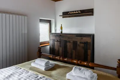 a bedroom with a bed with two towels on it at Wellba Holiday Home Otlica in Ajdovščina