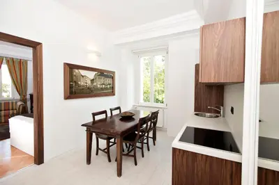 a kitchen and dining room with a table and chairs at Zois Apartments in Ljubljana