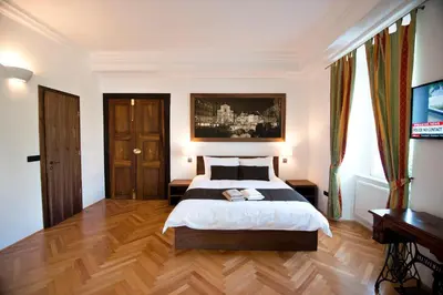 a bedroom with a bed and a wooden floor at Zois Apartments in Ljubljana
