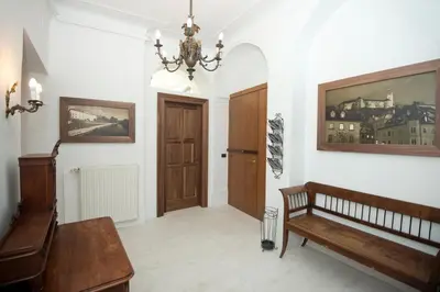 a hallway with a bench and a wooden door at Zois Apartments in Ljubljana