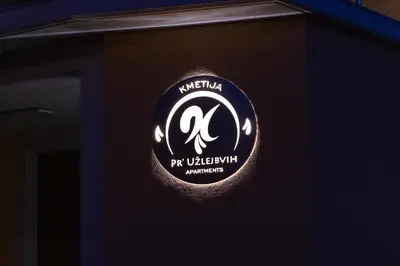 a sign on the side of a building at Apartments Pr' Užlejbvih in Podnanos