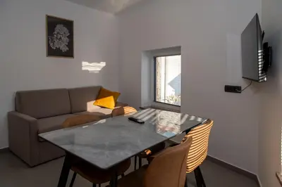 a living room with a table and a couch at Apartments Pr' Užlejbvih in Podnanos