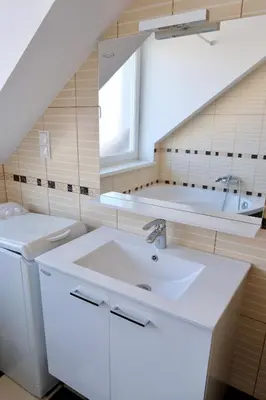 a bathroom with a sink and a bath tub at Apartma z dvema spalnicama in balkonom in Maribor