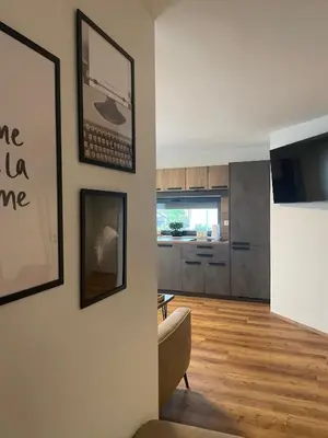 a living room with a couch and a kitchen at Apartments Wally in Ptuj