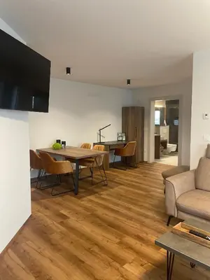 a living room with a table and a couch at Apartments Wally in Ptuj