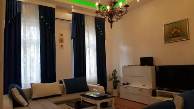 a living room with a couch and a tv at E&E Apartments in Ljubljana