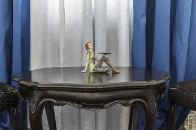 a figurine of a man sitting on a table at E&E Apartments in Ljubljana