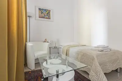 a bedroom with a bed and a glass table at E&E Apartments in Ljubljana