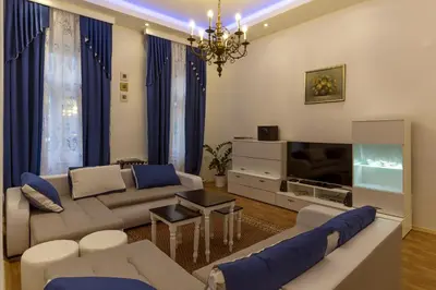 a living room with a couch and a tv at E&E Apartments in Ljubljana