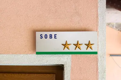 a sign on the side of a building with three stars at APARTMA in SOBE PILIH in Vipava