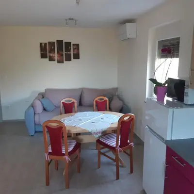 a living room with a table and chairs and a couch at APARTMA in SOBE PILIH in Vipava