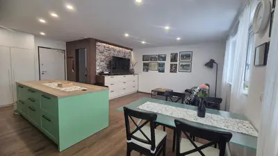 a kitchen with a table and a counter with chairs at TaWorld apartment in Šmartno pri Litiji