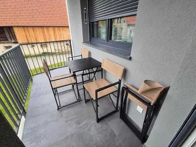 a balcony with chairs and a table on a balcony at TaWorld apartment in Šmartno pri Litiji