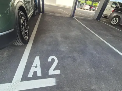 a parking lot with aania written on the ground at TaWorld apartment in Šmartno pri Litiji