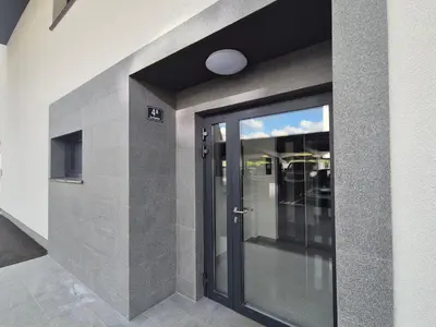 a glass door in a building with a window at TaWorld apartment in Šmartno pri Litiji