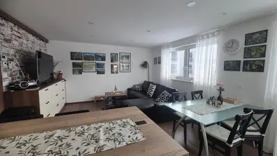a living room with a table and a couch at TaWorld apartment in Šmartno pri Litiji