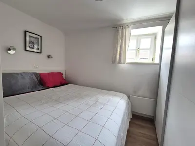 a small bedroom with a bed and a window at Valle Apartment City Center in Ljubljana