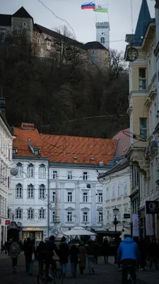 a group of people walking down a street with buildings at Valle Apartment City Center in Ljubljana