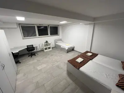 a bedroom with a bed and a desk in it at New Modern App in Ljubljana