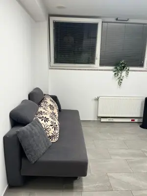a black couch sitting in a living room at New Modern App in Ljubljana