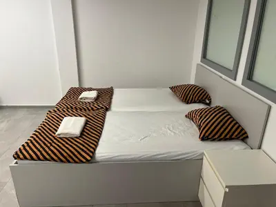 a bed with two pillows on it in a room at New Modern App in Ljubljana
