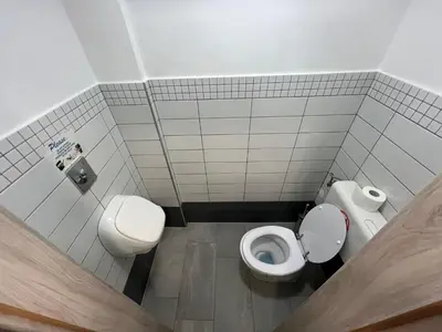 a bathroom with two toilets and a sink at New Modern App in Ljubljana