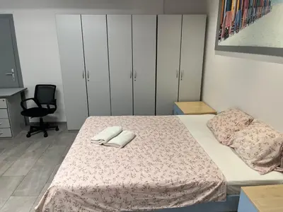 a bedroom with a bed with two towels on it at New Modern App in Ljubljana
