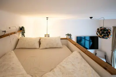a small room with a bed with two pillows at Urska's adorable place in Ljubljana