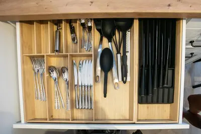 a wooden cabinet with utensils hanging from it at Urska's adorable place in Ljubljana