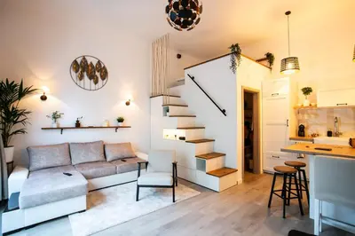 a living room with a couch and a stairway at Urska's adorable place in Ljubljana