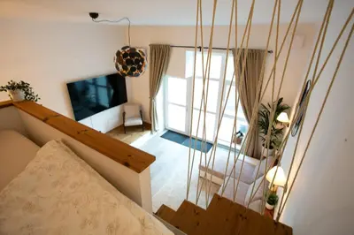 a view of a room with a bed and a television at Urska's adorable place in Ljubljana