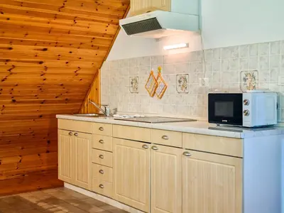 a kitchen with a sink and a microwave at Apartmaji Čok in Bovec
