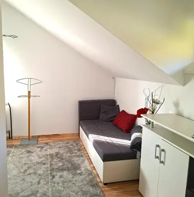 a room with a bed in the corner of a room at Holiday house Zala in Puconci