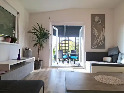 a living room with a couch and a table at Holiday house Zala in Puconci