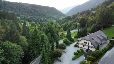 an aerial view of a house in the mountains at Dih narave in Stahovica