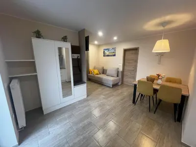 a living room with a table and a dining room at Dih narave in Stahovica