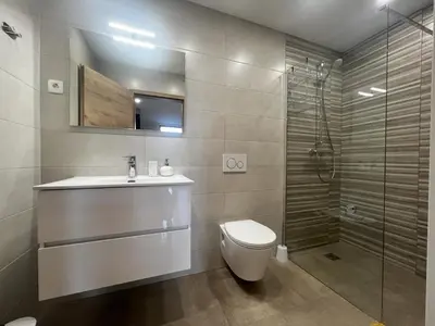 a bathroom with a toilet and a sink and a shower at Dih narave in Stahovica