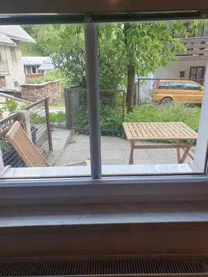 a window view of a bench and a picnic table at ALPINE VILLAGE APARTMENT with a private terrace, garden, and parking - at a walking distance from LAKE BLED in Bohinjska Bela