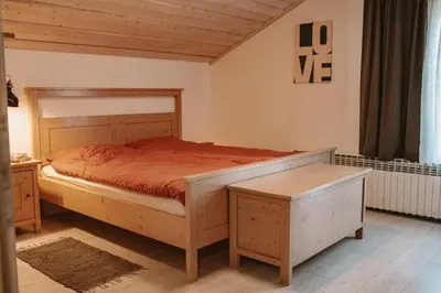 a bedroom with a bed with a wooden bed frame at Green Hill in Jesenice na Dolenjskem