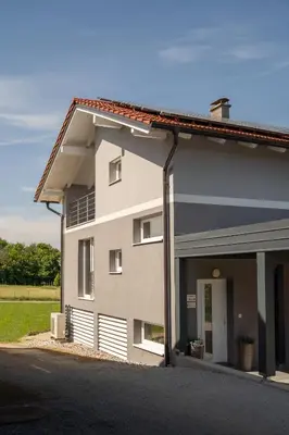 a building with a garage in front of it at Green Hill in Jesenice na Dolenjskem