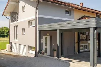 a white house with awning in front of it at Green Hill in Jesenice na Dolenjskem