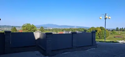 a stone fence with a view of a park at Green Hill in Jesenice na Dolenjskem