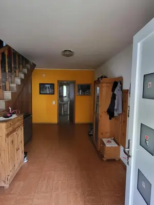 an empty hallway with yellow walls and a staircase at Apartma Magdalena in Kobarid